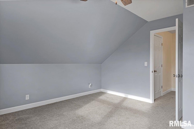 additional living space with ceiling fan, light colored carpet, and lofted ceiling