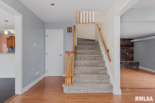 stairs featuring hardwood / wood-style floors