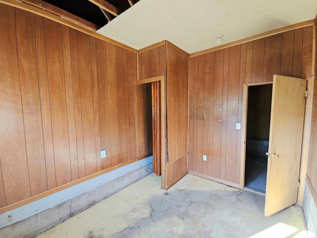 unfurnished room with wood walls