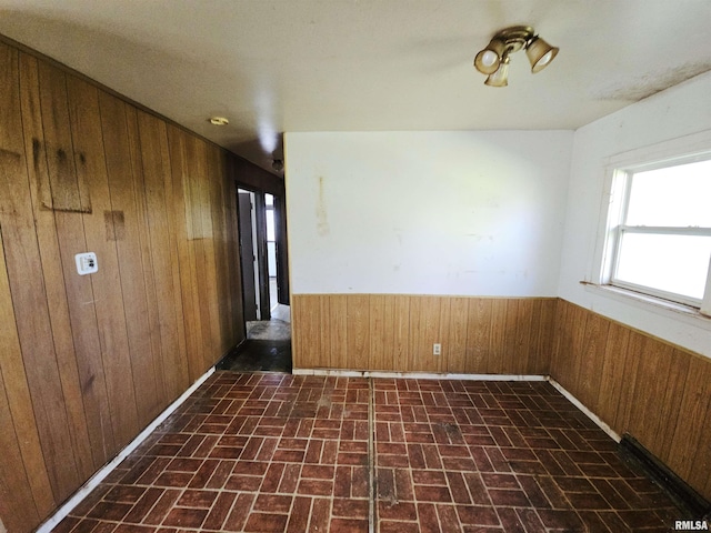 empty room featuring wooden walls