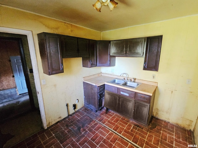 kitchen featuring dark brown cabinetry and sink