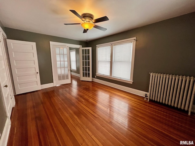 interior space with french doors, radiator, dark wood-type flooring, and ceiling fan