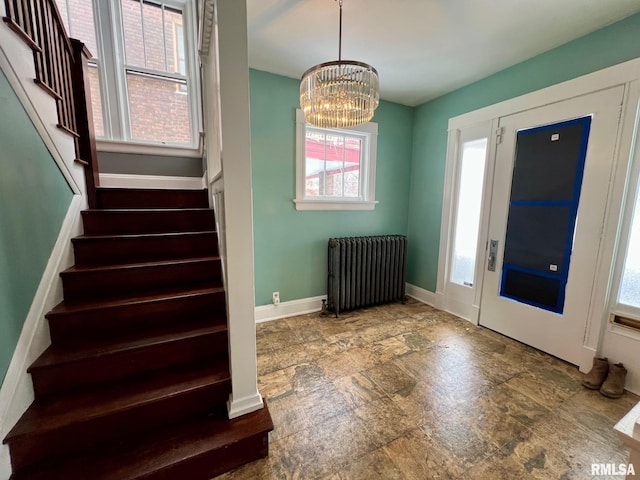 foyer with a chandelier and radiator heating unit