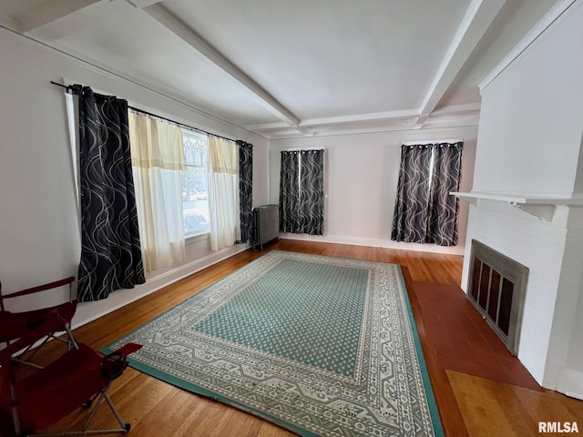 sitting room with hardwood / wood-style floors and beam ceiling