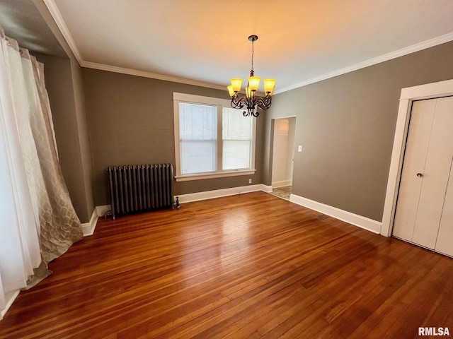 unfurnished room featuring radiator heating unit, an inviting chandelier, ornamental molding, and hardwood / wood-style floors