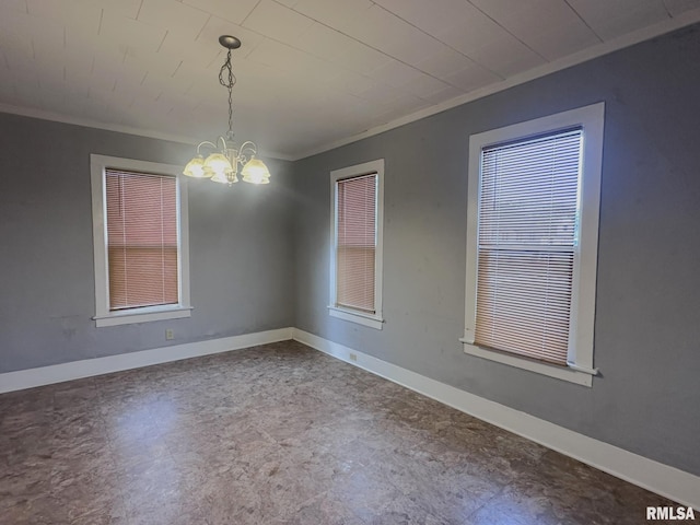 spare room featuring a notable chandelier and ornamental molding