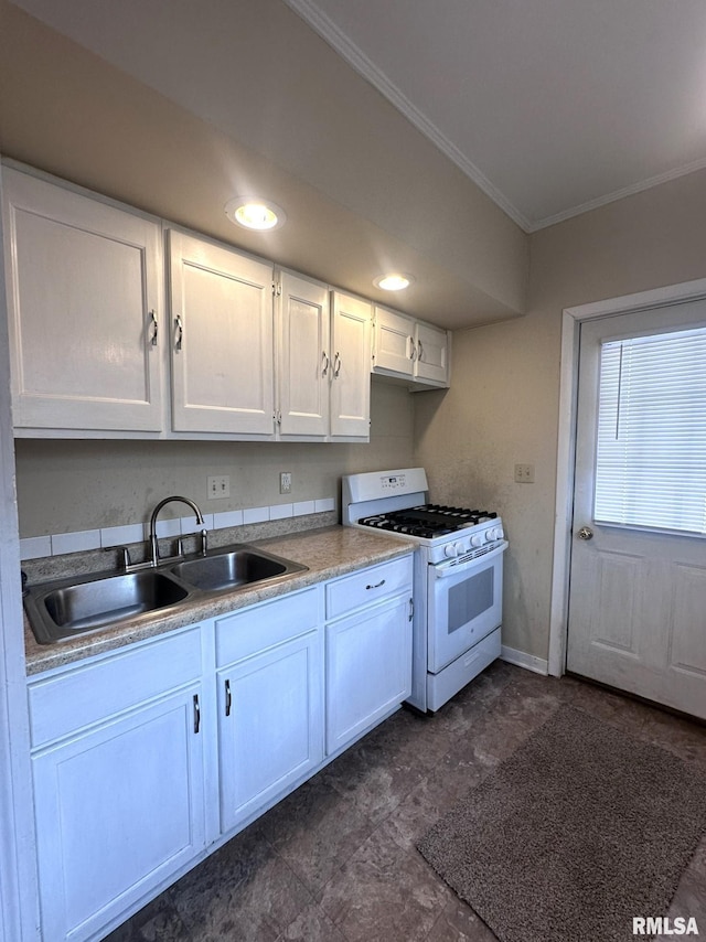 kitchen featuring white gas range, crown molding, sink, and white cabinets