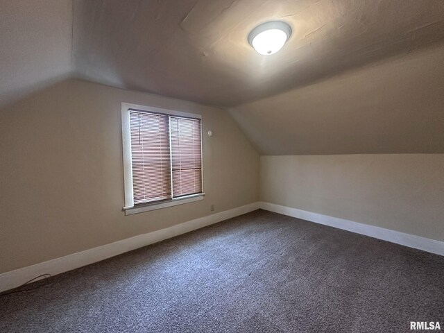 bonus room featuring carpet flooring and vaulted ceiling