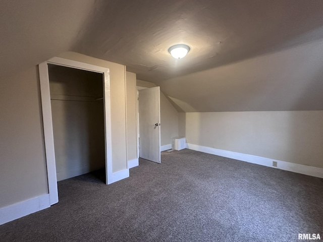 bonus room featuring dark carpet and lofted ceiling