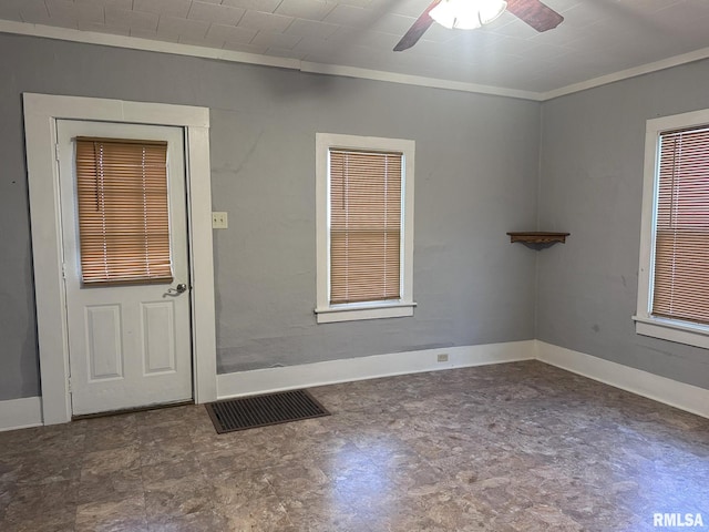 interior space with ceiling fan and ornamental molding