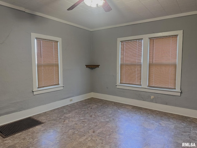 unfurnished room with ceiling fan and ornamental molding