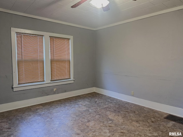 empty room featuring ceiling fan and ornamental molding