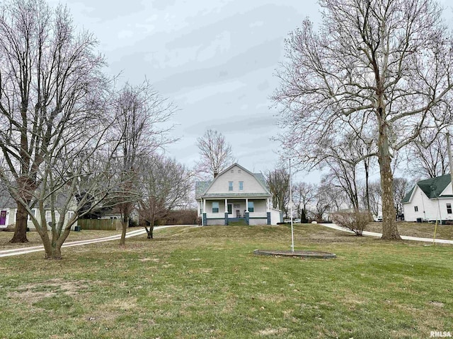 view of front of property with covered porch and a front lawn