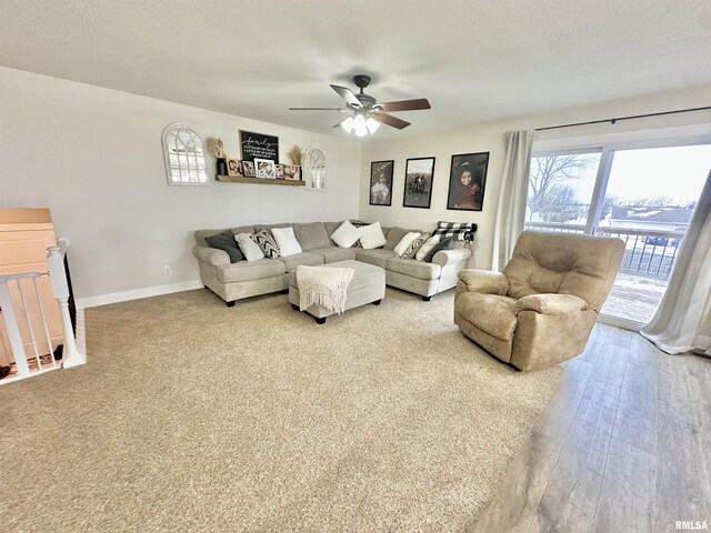 living room featuring a textured ceiling, light hardwood / wood-style flooring, and ceiling fan