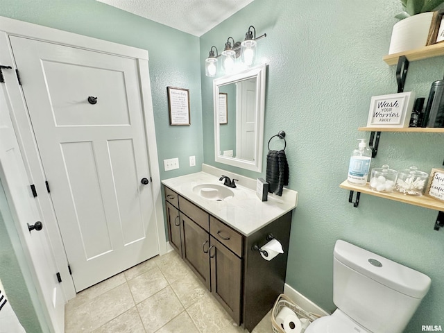 bathroom featuring tile patterned flooring, vanity, toilet, and a textured ceiling