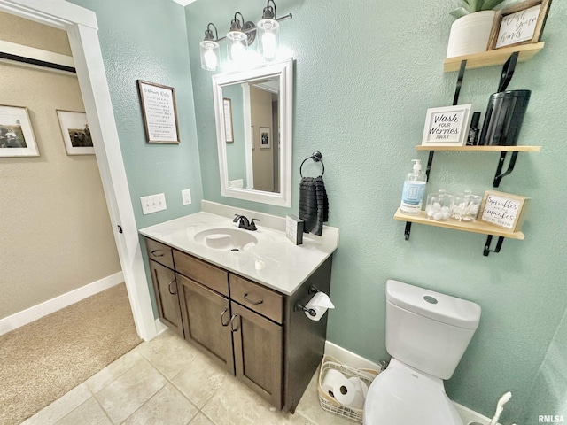 bathroom featuring tile patterned floors, vanity, and toilet