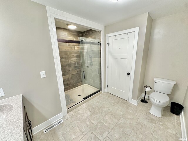 bathroom featuring vanity, toilet, and walk in shower