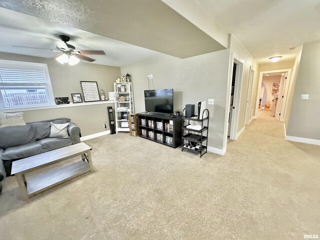 carpeted living room with ceiling fan