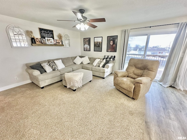 living room featuring a textured ceiling, hardwood / wood-style flooring, and ceiling fan