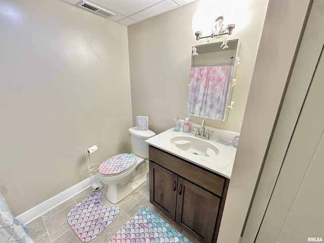 bathroom with tile patterned flooring, vanity, and toilet