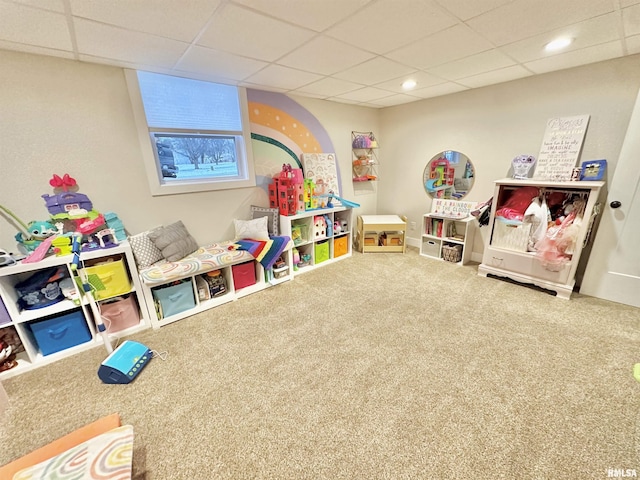 rec room with carpet and a paneled ceiling