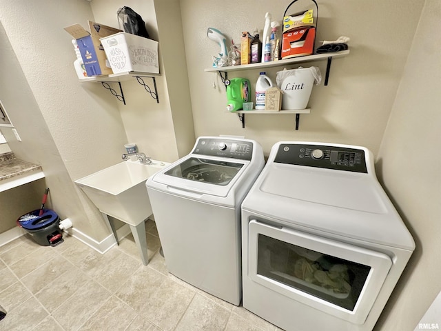 clothes washing area with washer and clothes dryer