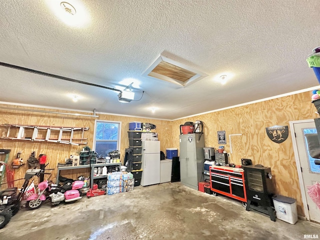 garage featuring wood walls and a garage door opener