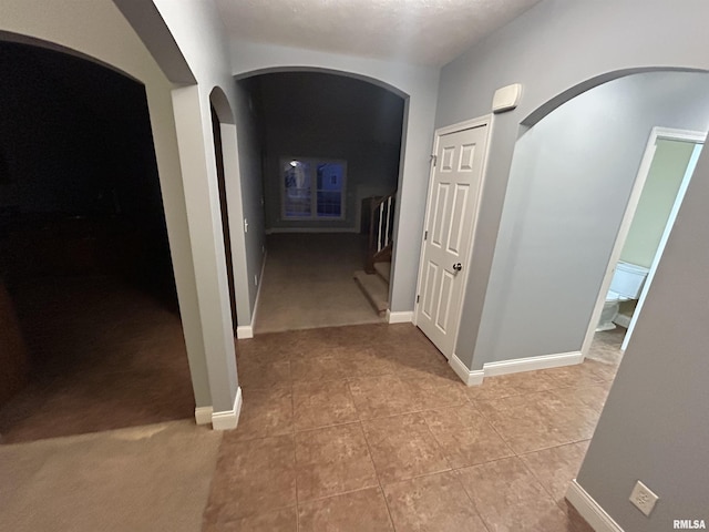 hallway with light colored carpet