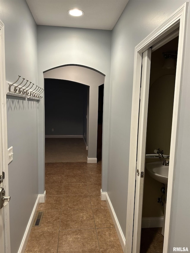 corridor with dark tile patterned flooring