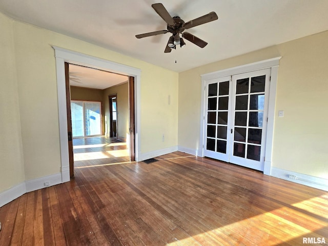 unfurnished room featuring hardwood / wood-style floors, ceiling fan, and french doors