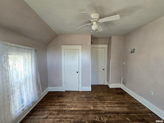 unfurnished bedroom featuring ceiling fan, dark wood-type flooring, and vaulted ceiling