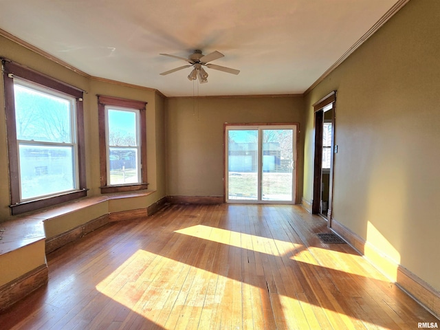 spare room with ceiling fan, light hardwood / wood-style floors, plenty of natural light, and crown molding