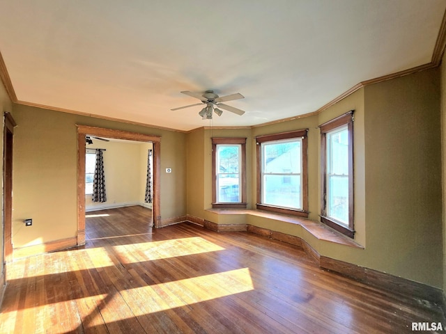 spare room with hardwood / wood-style floors, ceiling fan, and ornamental molding