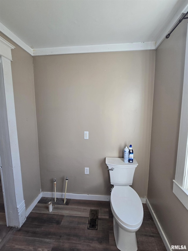 bathroom featuring hardwood / wood-style flooring and toilet