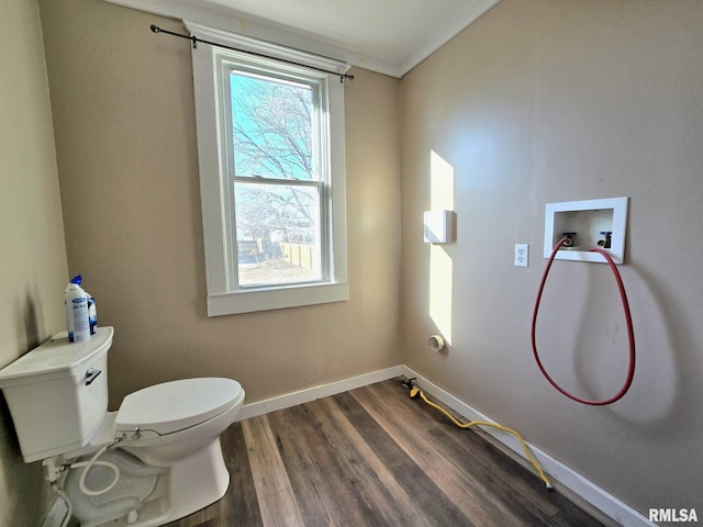 bathroom featuring wood-type flooring, toilet, and ornamental molding