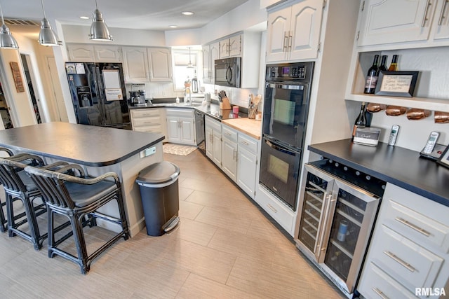 kitchen with black appliances, wine cooler, decorative backsplash, decorative light fixtures, and white cabinetry