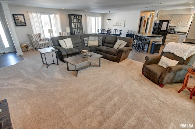 carpeted living room featuring a healthy amount of sunlight