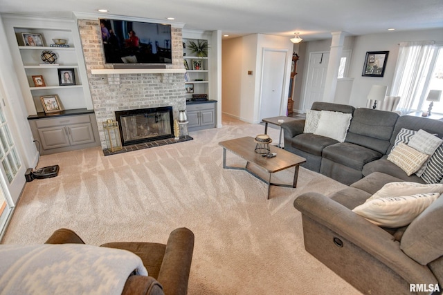 carpeted living room featuring a fireplace and built in features