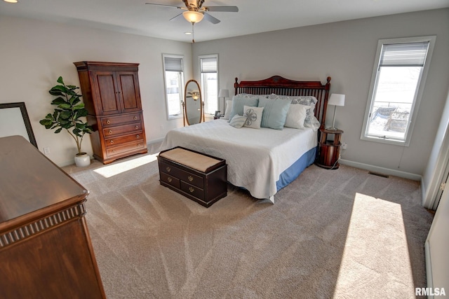 bedroom featuring light carpet and ceiling fan