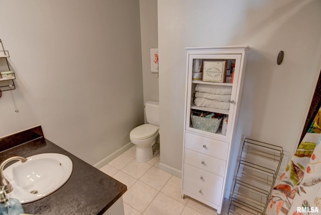 bathroom featuring tile patterned flooring, vanity, and toilet