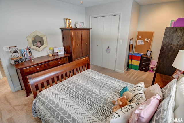 bedroom featuring light carpet and a closet