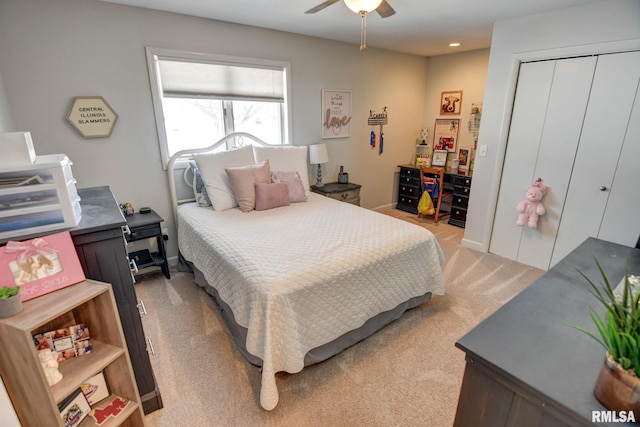 bedroom featuring light carpet, a closet, and ceiling fan