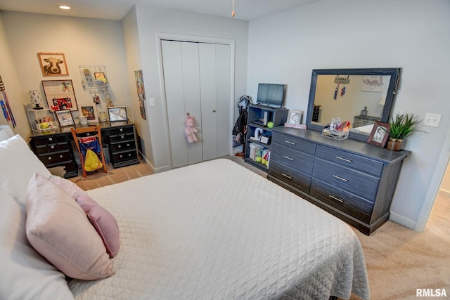 bedroom with light colored carpet and a closet