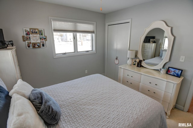 bedroom with carpet and a closet