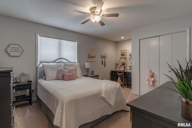 bedroom with light carpet, a closet, and ceiling fan