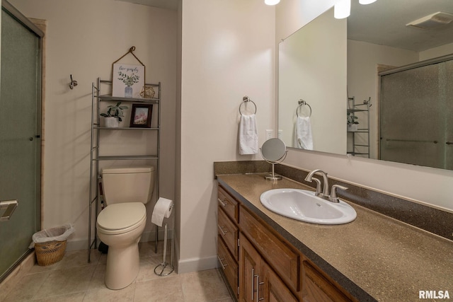 bathroom featuring an enclosed shower, vanity, toilet, and tile patterned flooring