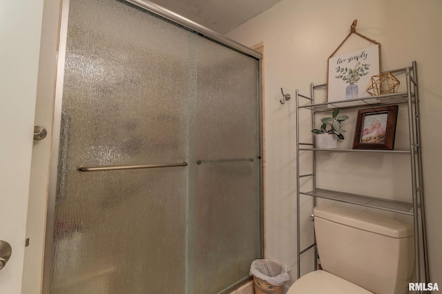 bathroom featuring an enclosed shower and toilet