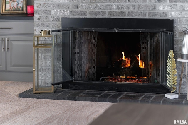 interior details with carpet floors and a fireplace