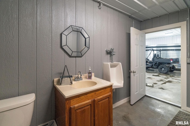 bathroom with vanity, concrete floors, and toilet