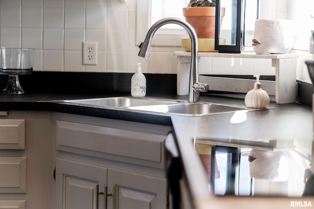 room details with decorative backsplash and sink